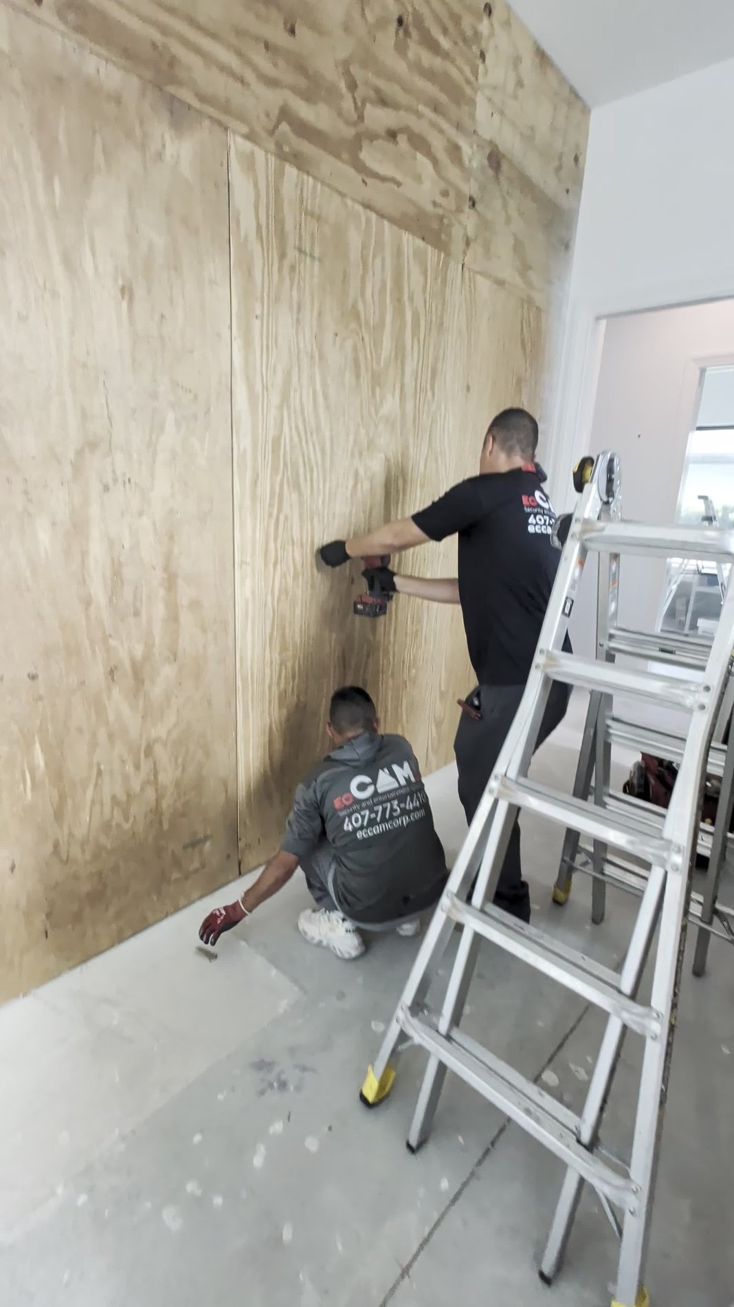 ECCAM electrical technicians framing the base structure for a backlit stone wall, Winter Park